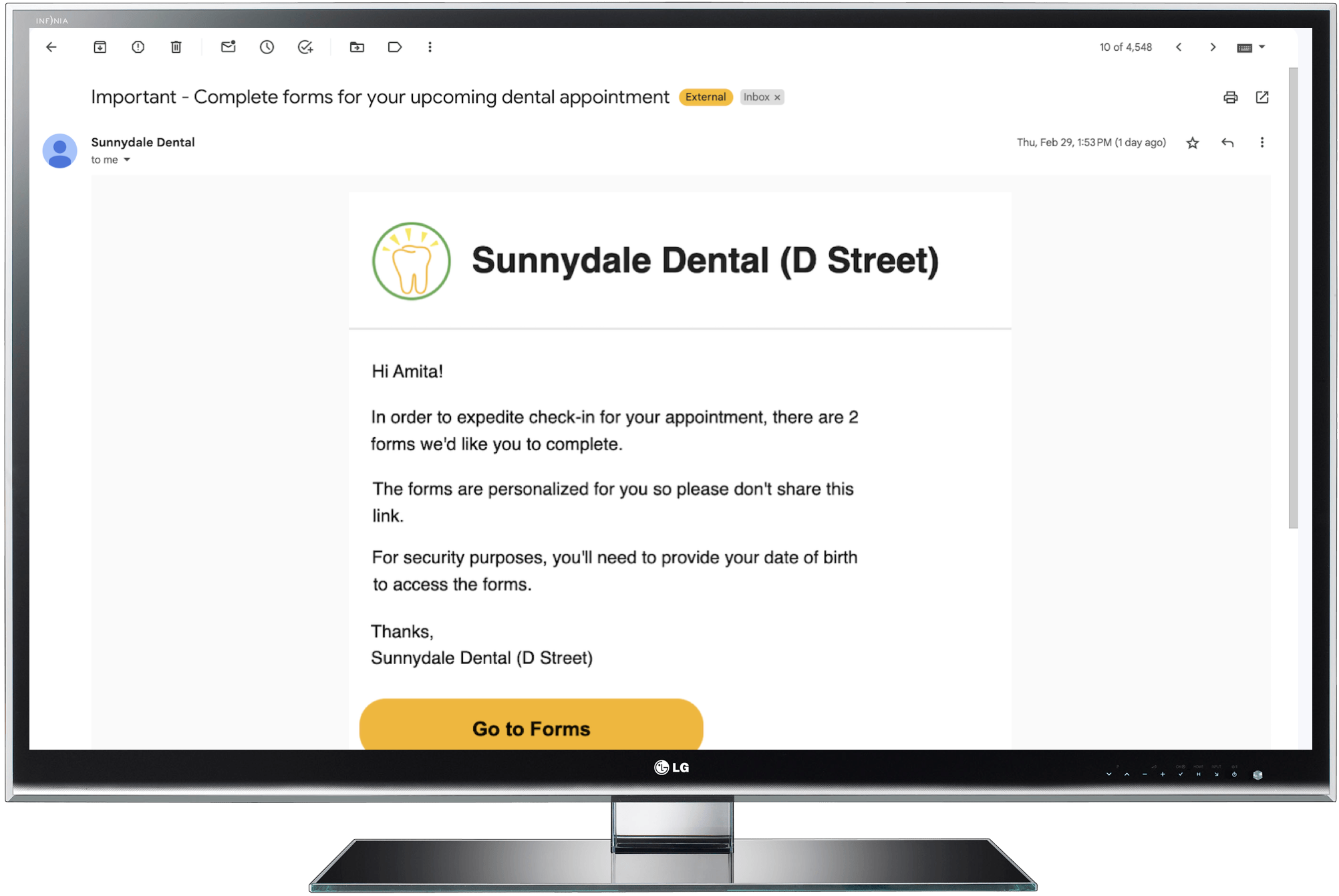 Computer monitor showing patient email from practice asking them to complete forms for their appointment and a Go to Forms link.