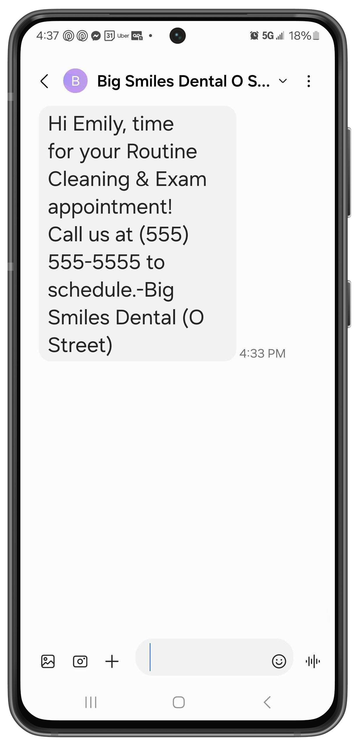 Phone with a text letting a patient know it's time to coming in for an appointment and and lists the practice name and phone number.